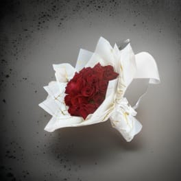 Bouquet of red roses wrapped in white paper
