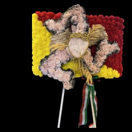 Floral arrangement shaped like a figure with red and yellow flowers