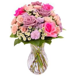 Pink and lavender rose bouquet in a clear glass vase