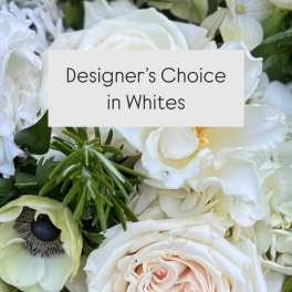 White floral arrangement with roses and mixed blooms