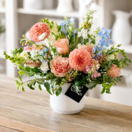 Mixed pastel flower arrangement in a white vase