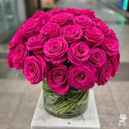 Bouquet of bright pink roses in a clear glass vase