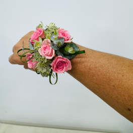 Pink rose and green filler Corsage.