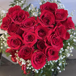 Bouquet of red roses with white baby's breath and a red ribbon