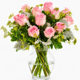Pink roses arranged in a clear glass vase