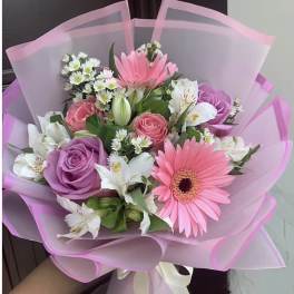 Pink and purple bouquet with gerbera daisies, roses, and white flowers