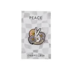 Enamel pin with a peace sign and flowers on a backing card