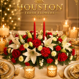 Red and white floral centerpiece with candles on a decorated table