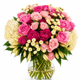 Pink and cream rose bouquet in a clear glass vase