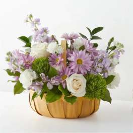 Basket arrangement of lavender and white flowers with green accents