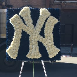 White floral monogram on a dark blue display board