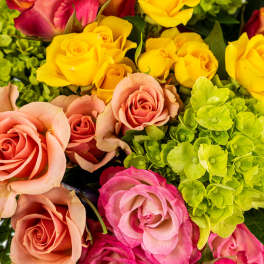 Mixed bouquet of roses in yellow, peach, pink, and green