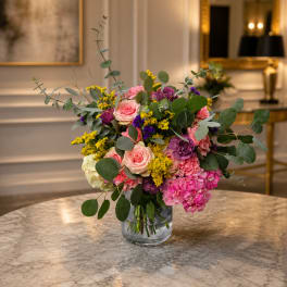 Mixed pink and purple bouquet in a clear glass vase