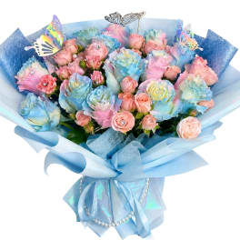 Bouquet of pastel roses wrapped in blue paper with butterfly picks