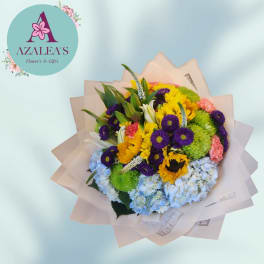 Mixed bouquet with sunflowers, purple daisies, and blue hydrangeas in paper wrap