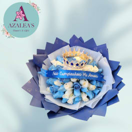 Blue and white rose bouquet with a jeweled crown and birthday ribbon
