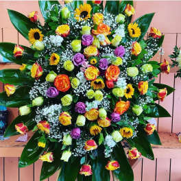 Large mixed bouquet with roses, sunflowers, and white filler flowers