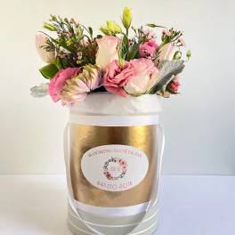 Pink and cream mixed bouquet in a gold cylindrical box