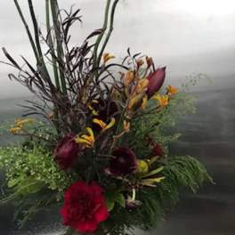 Tall tropical bouquet with red and burgundy flowers