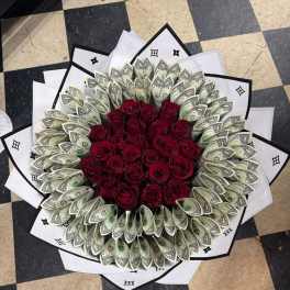 Bouquet of red roses surrounded by folded dollar bills