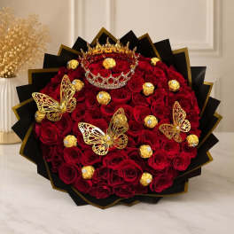 Bouquet of red roses with gold butterfly decorations and chocolates