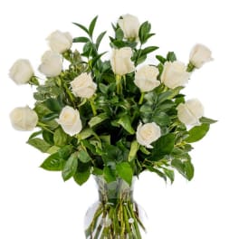 White roses arranged in a clear glass vase