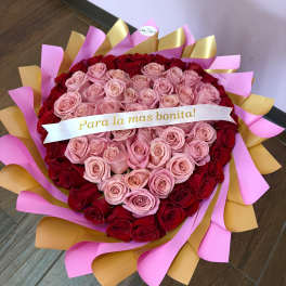 Heart-shaped bouquet of pink and red roses with a ribbon banner