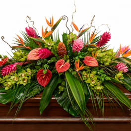 Tropical floral casket spray with pink, orange, and green blooms