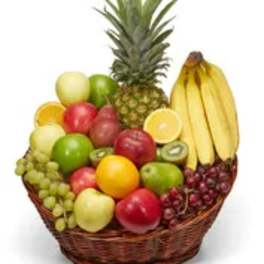 Basket of assorted fruit with a pineapple and bananas
