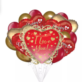 Cluster of red, pink, and gold heart-shaped balloons with love messages