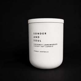 White candle jar labeled Sonder and Soul Coconut Lemongrass