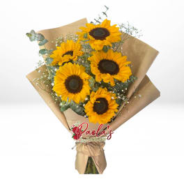 Bouquet of sunflowers wrapped in brown paper with a ribbon
