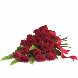 Red rose bouquet with a satin ribbon on a white background
