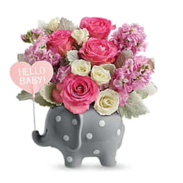 Pink and white flower arrangement in a gray elephant vase with a "Hello Baby!" sign