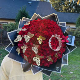 Large bouquet of red roses with butterfly decorations and black wrapping