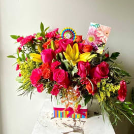 Bright mixed bouquet with roses, lilies, and carnations in a gift box