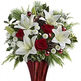 Red roses and white lilies in a red glass vase