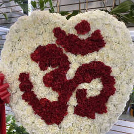 Heart-shaped white and red carnation funeral spray