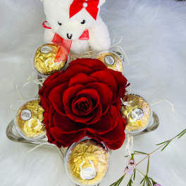 Red rose arrangement with a teddy bear and Ferrero Rocher chocolates