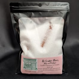 Bag of white bath salts with a pink label