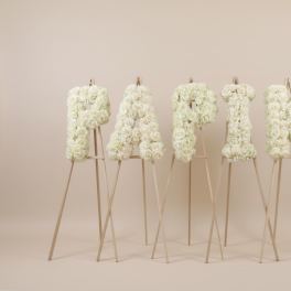 White floral letters spelling PARTY on easels