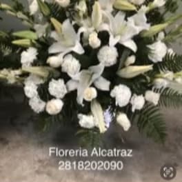 White lilies and roses arranged in a large standing spray