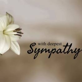 White lilies beside sympathy text on a beige card