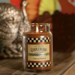 Lit chestnut-scented candle in a glass jar