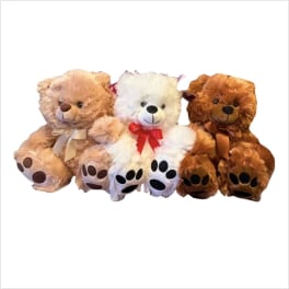 Three teddy bears with ribbon bows sitting together