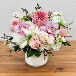 Pink and white floral arrangement in a white vase