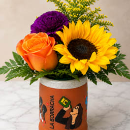 Orange rose, yellow sunflower, and purple chrysanthemum in a painted vase