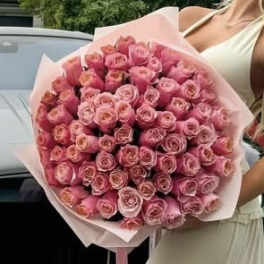 Large bouquet of pink roses wrapped in pale pink paper