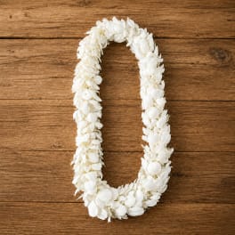 White flower lei on a wooden surface