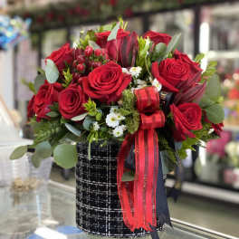 Red rose bouquet in a black patterned box with ribbon